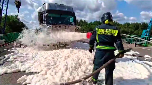 A rescue worker sprays foam