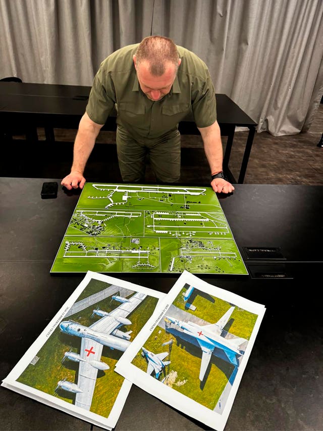 Security Service head Vasyl Malyuk studies a photo of a map