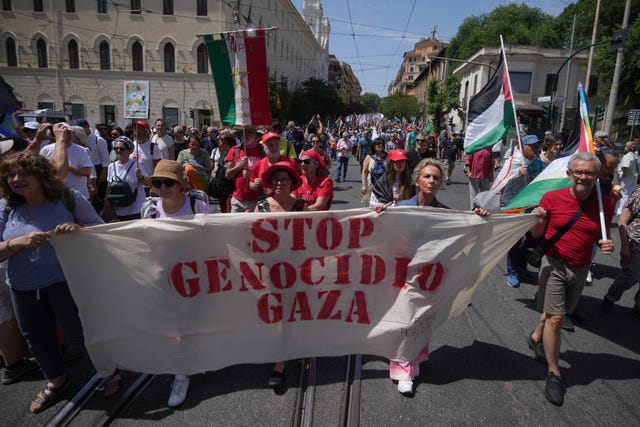 Demonstrators bear a banner