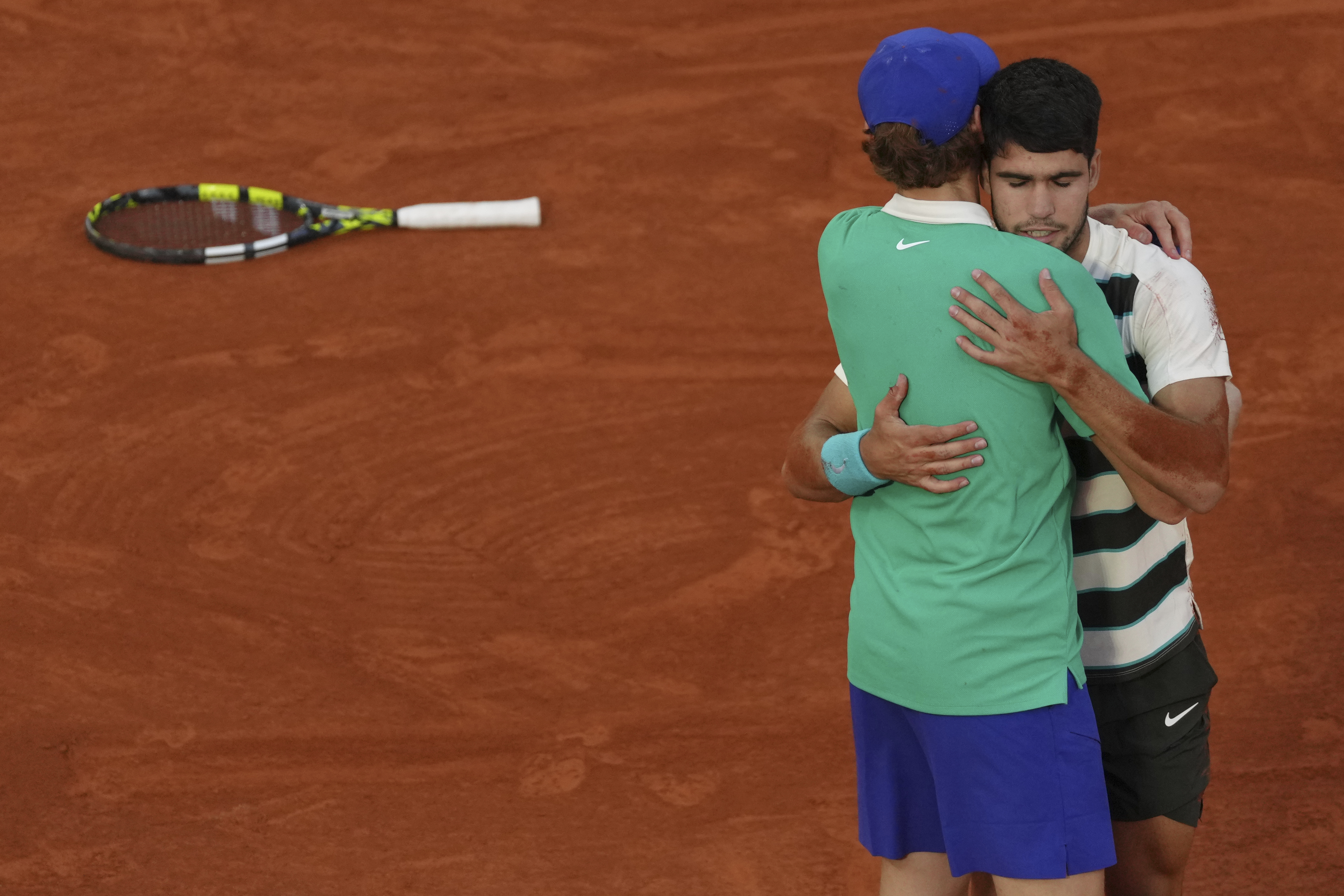 Carlos Alcaraz and Jannik Sinner embrace