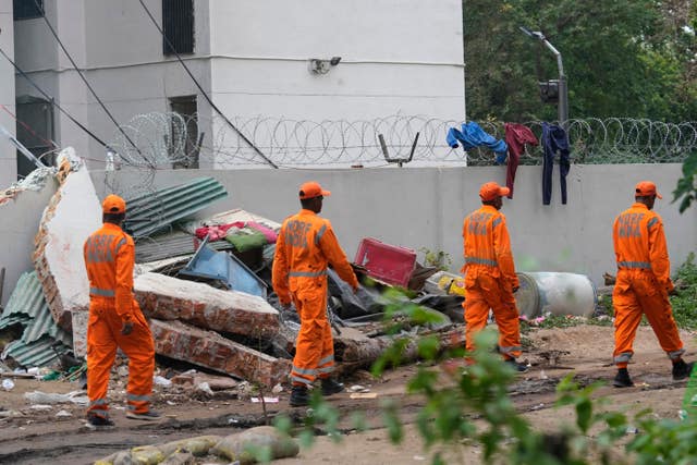 Members of National Disaster Response Force arrive at the scene