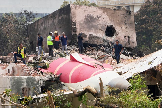 Plane upside down among rubble and trees