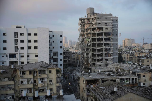 Israeli security forces inspect destroyed buildings that were hit by a missile fired from Iran, near Tel Aviv, Israel