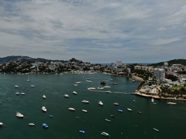 Boats are anchored near Manzanillo beach to be removed from the water ahead of the arrival of Hurricane Erick in Acapulco
