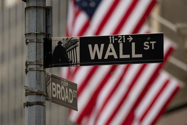 A Wall Street sign hangs near to the New York Stock Exchange