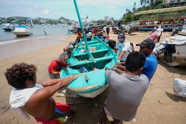 Boats are removed from the water to Manzanillo beach ahead of the arrival of Hurricane Erick in Acapulco
