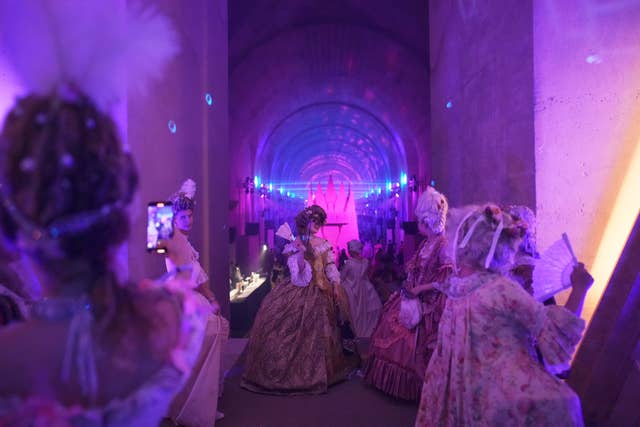 Costumed guests attend the Great Masked Ball