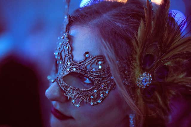 A costumed guest attends the Great Masked Ball