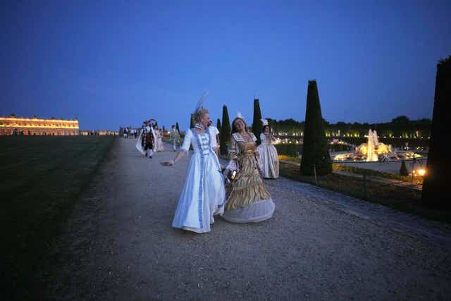Costumed guests run in the gardens