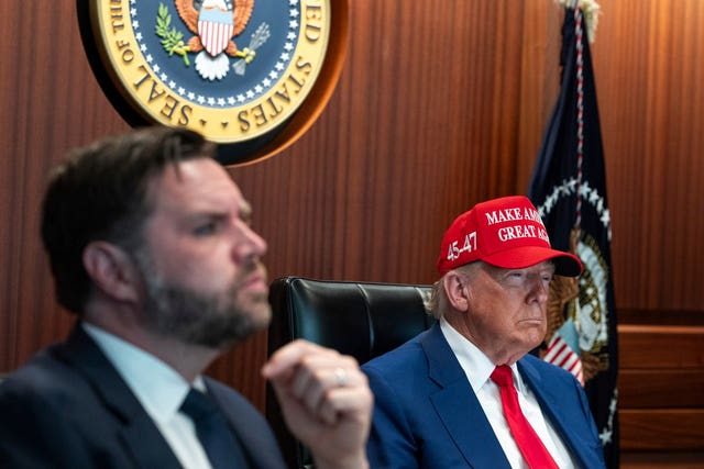 JD Vance sitting alongside Donald Trump