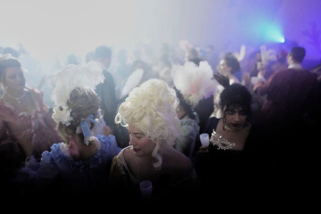 Costumed guests dance during the Great Masked Ball