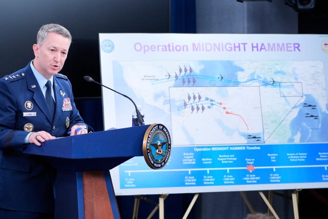 Dan Caine speaks in front of a map titled Operation Midnight Hammer