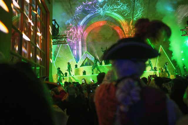 Costumed guests watch performers at the Great Masked Ball