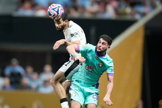 Manchester City’s Rayan Ait-Nouri jumps above an opponent to head the ball