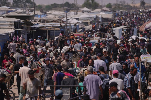 Palestinians carry bags containing food and humanitarian aid packages delivered by the Gaza Humanitarian Foundation, a US-backed organisation, in Rafah, southern Gaza Strip