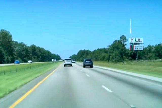 A bright object in the sky above a road