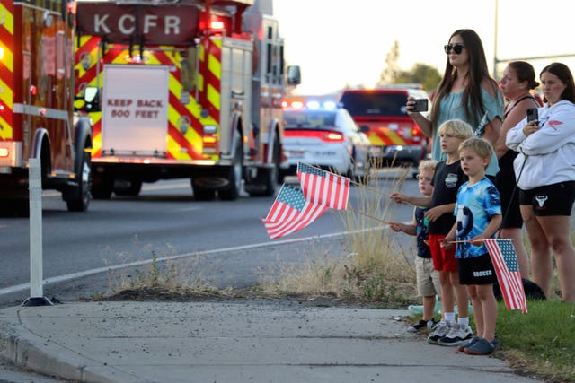 A fire engine is saluted by the public