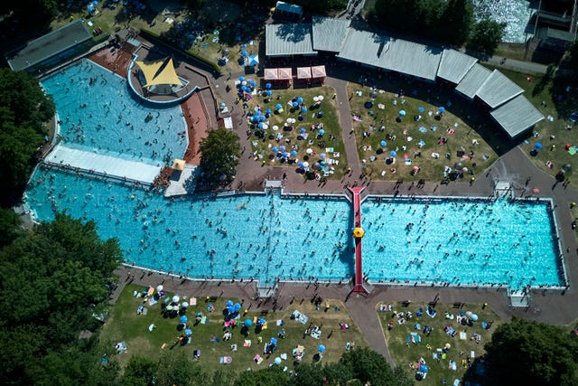 People visit a public pool in Frankfurt, Germany