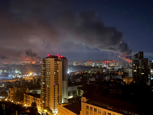 Smoke rises above the evening skyline in Kyiv