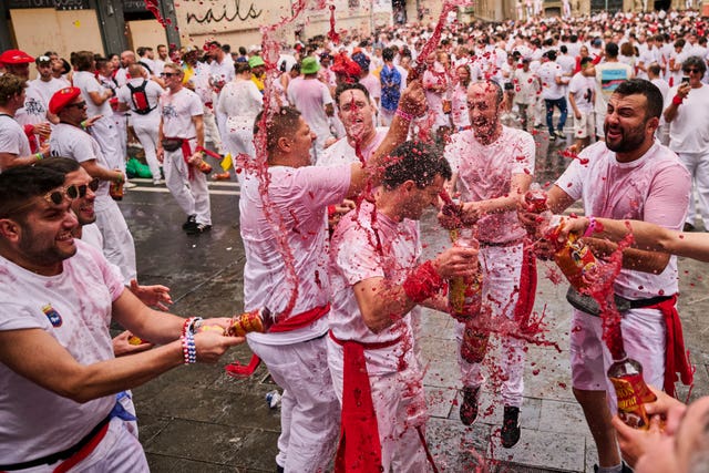 Revellers spray red drinks at each other in Pamplona
