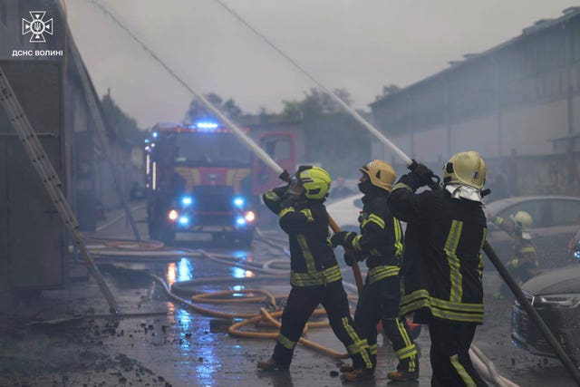 Firefighters tackle a blaze following a Russian attack in Volyn region