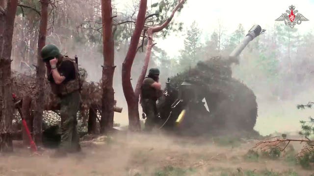 Russian soldiers fire from a D-30 howitzer towards Ukrainian positions in Ukraine