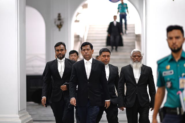 Chief prosecutor Mohammad Tajul Islam, second left, arrives to speak to the media after a special tribunal indicted Bangladesh’s ousted prime minister Sheikh Hasina by accepting charges of crimes against humanity filed against her at the International Crimes Tribunal in Dhaka, Bangladesh