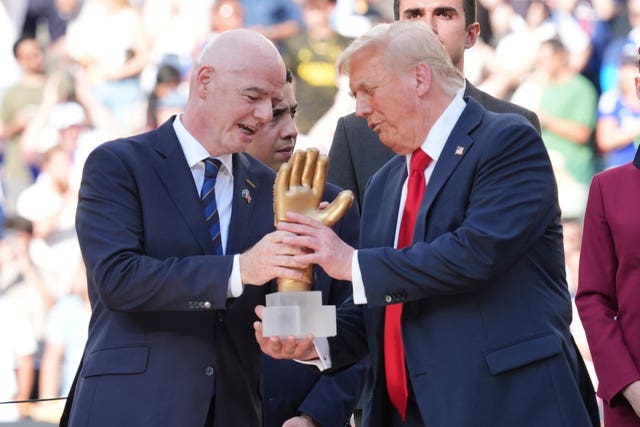 President Donald Trump (right) and FIFA President Gianni Infantino hold the Golden Glove award at the conclusion of the Club World Cup final