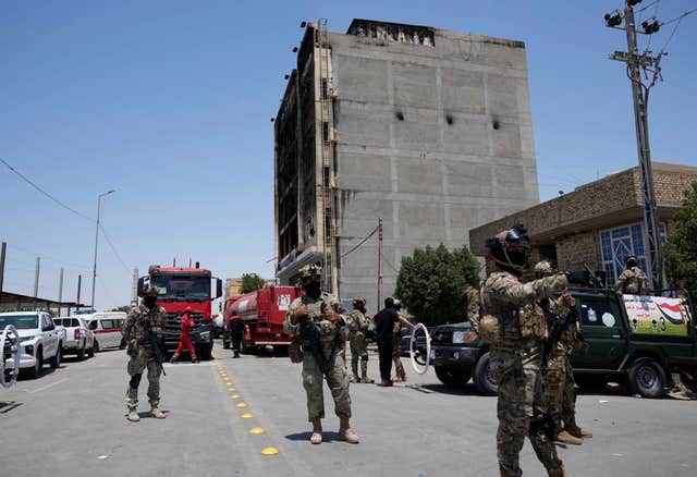 Iraqi security forces at the scene of the fire in Kut