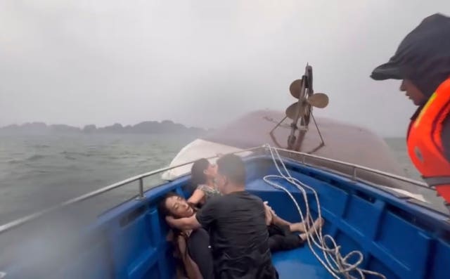 People in distress sitting on a rescue boat