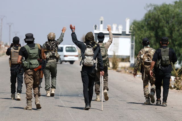 Bedouin fighters gather in a village in southern Syria