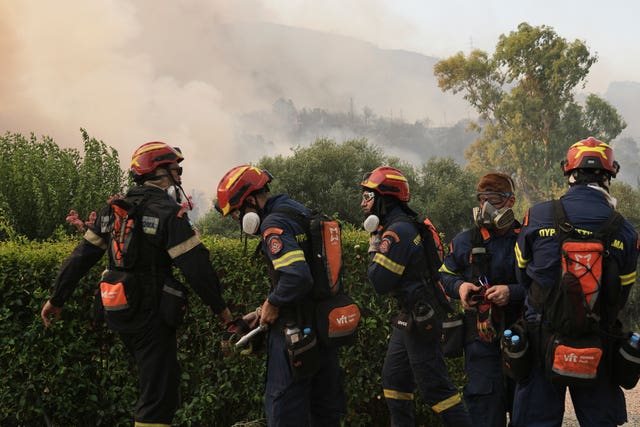 Firefighters prepare to fight a wildfire on the outskirts of Patras, western Greece