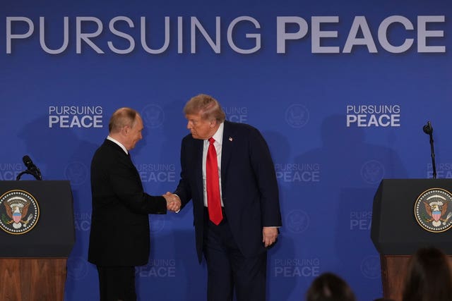 Donald Trump, right, shakes the hand of Russia’s President Vladimir Putin during a joint press conference in Alaska following their talks over Ukraine