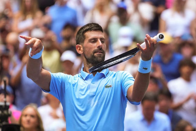 Novak Djokovic pretends to play the violin in celebration after beating Zachary Svajda