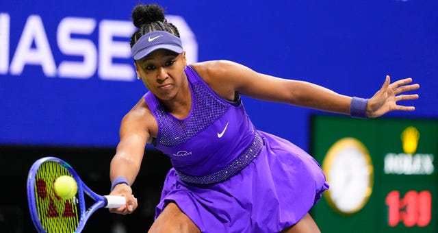 Naomi Osaka returns a shot to Amanda Anisimova