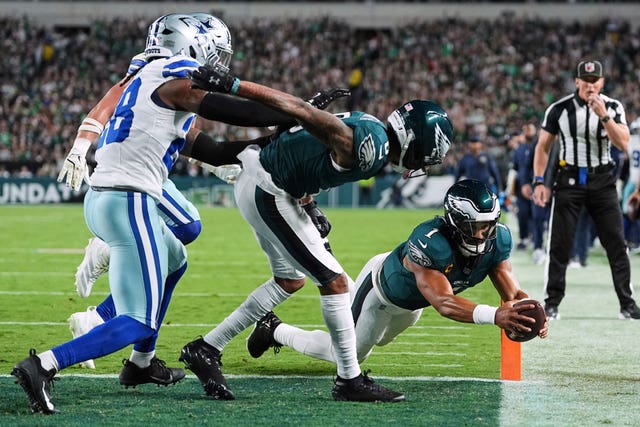 Philadelphia Eagles quarterback Jalen Hurts dives into the end zone to score a touchdown