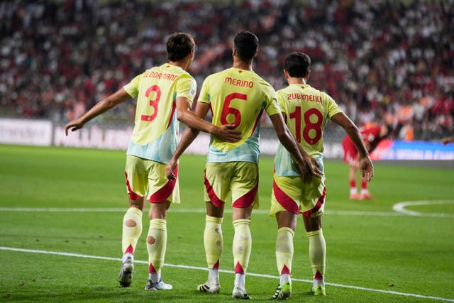 Spain’s Mikel Merino (centre) celebrates with his team-mates