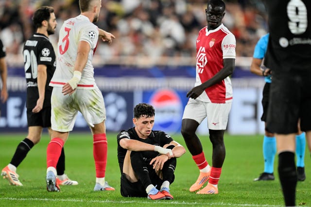 Phil Foden sits on the pitch