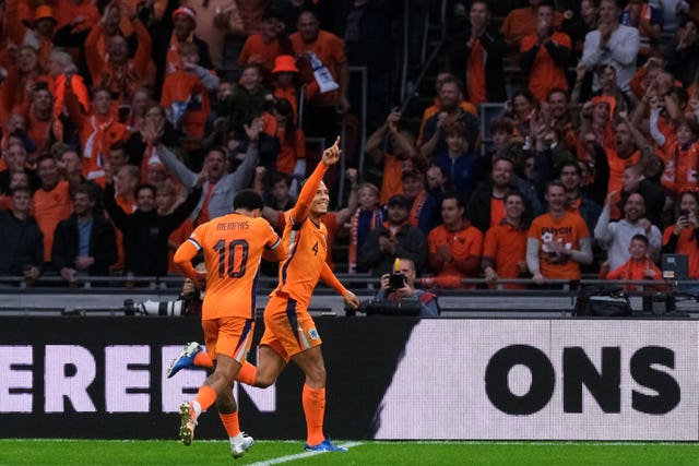Netherlands’ Virgil van Dijk celebrates with Memphis Depay after scoring for the Netherlands