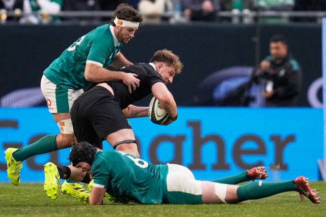 New Zealand’s Fabien Holland is tackled by Ireland’s Ryan Baird, bottom, and Finlay Bealham, left