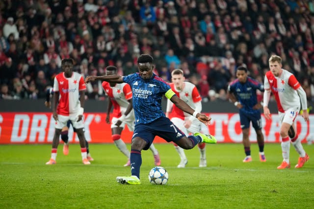 Bukayo Saka strikes the ball from the penalty spot, putting Arsenal ahead against Slavia Prague
