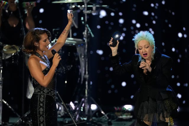 Raye, left and Cyndi Lauper perform