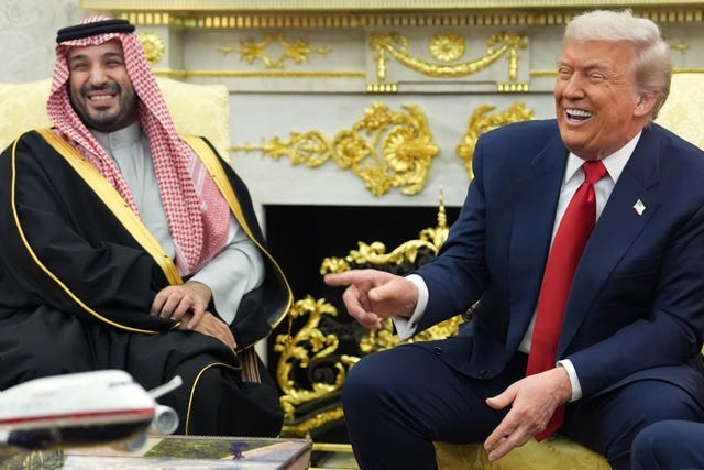 President Donald Trump and Crown Prince Mohammed bin Salman laughing in the Oval Office