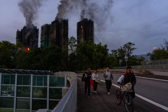 The smoking tower blocks in the dawn light