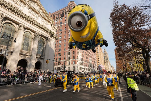 Balloon handlers guide the Stuart the Minion balloon down Central Park West during the Macy’s Thanksgiving Day Parade in New York