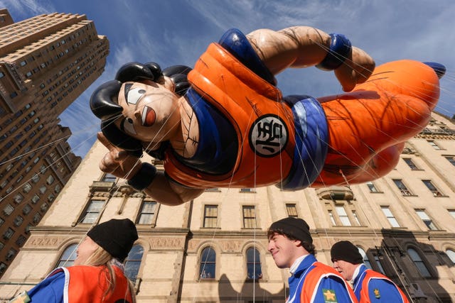 Balloon handlers guide the Goku balloon down Central Park West during the Macy’s Thanksgiving Day Parade in New York