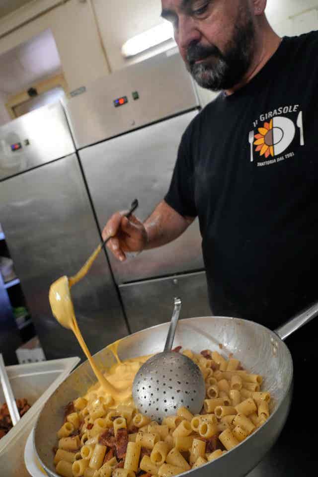 Massimo Dante prepares food at his restaurant in Rome