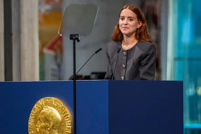 Ana Corina Sosa, the daughter of the Nobel Peace Prize laureate, accepts the award on behalf of her mother