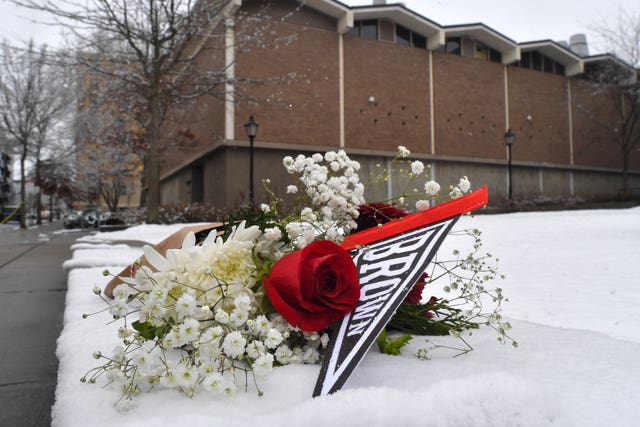 A bouquet of flowers rests on snow on the campus of Brown University