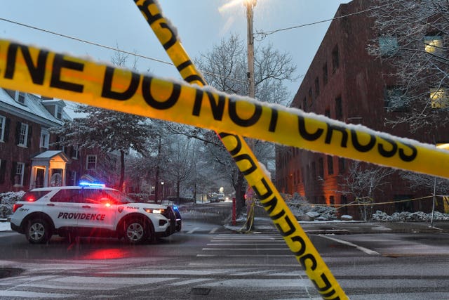A police vehicle at a cross roads near crime scene tape at Brown University
